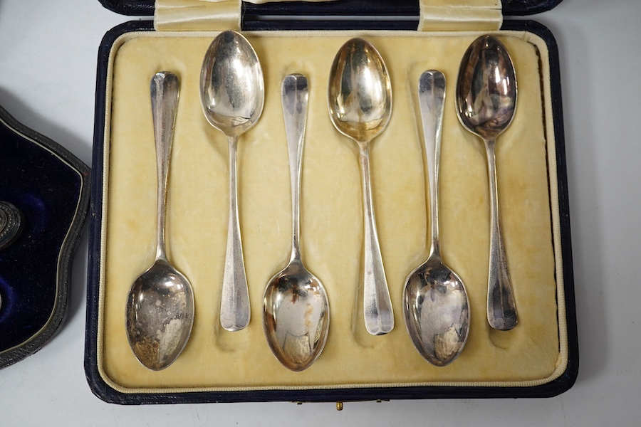 A cased Victorian engraved silver four piece christening set, by William Hutton & Sons Ltd, London, 1895, comprising a spoon, knife, fork and napkin ring, together with a cased set of six silver teaspoons, a cased pair o